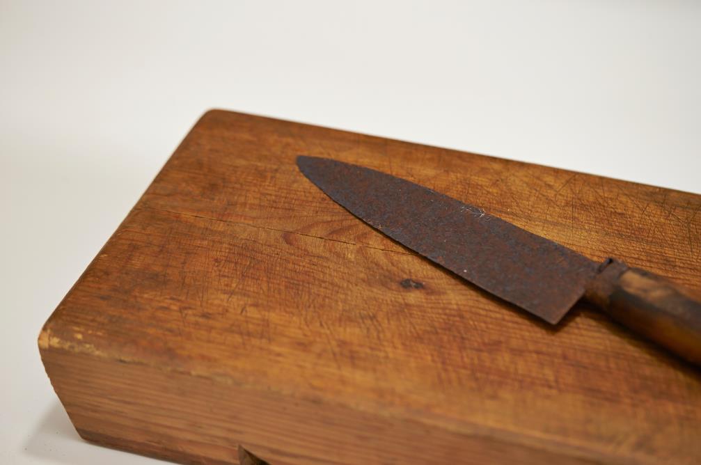 Rust knife on wooden cutting board