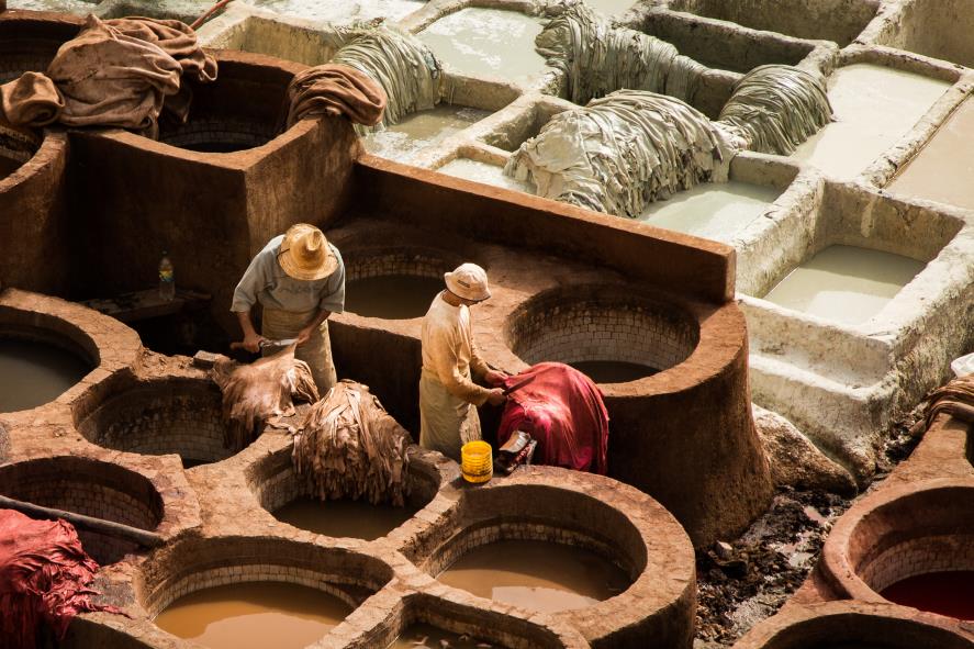 Men working in a tannery in Morocco with many colors