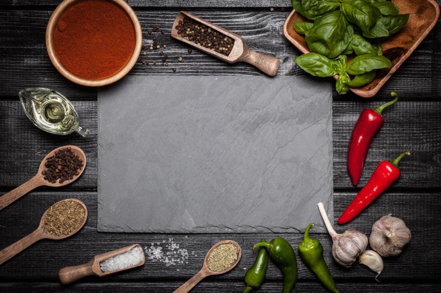 Stone made cutting board surrounded with ingredients