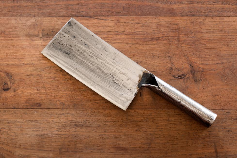 Chinese cleaver sitting on wooden background generic image