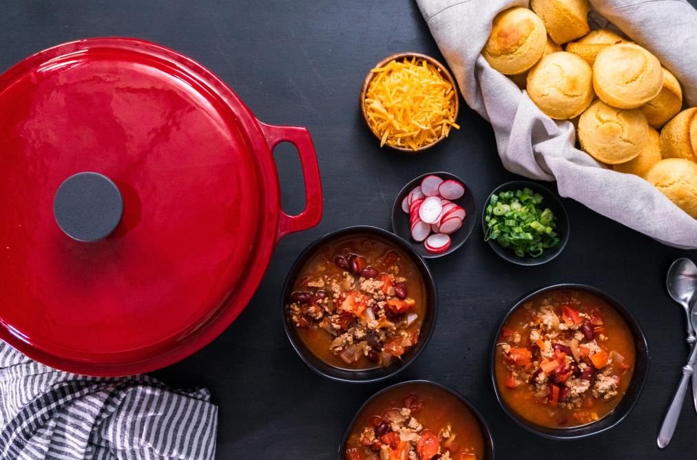 Enameled cast iron cookware with soup and food