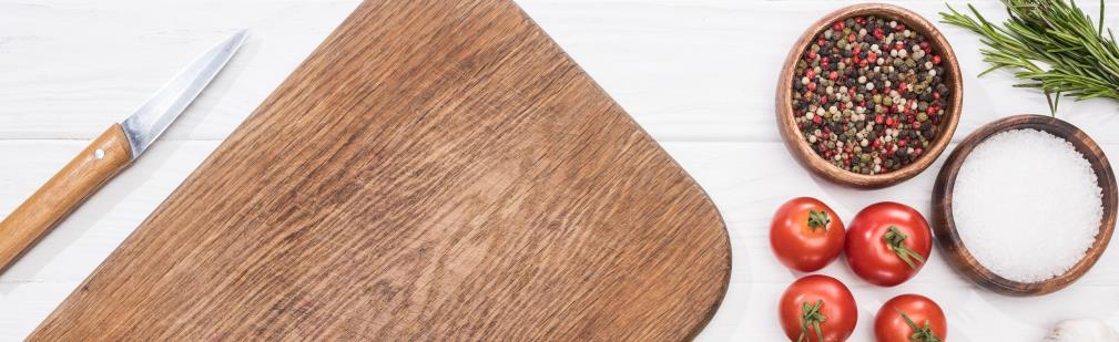 cheery wood cutting board with knife, salt, pepper